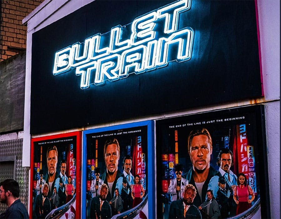 bullet train movie theater neon sign